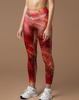 Shimmering gold glitter on red background leggings